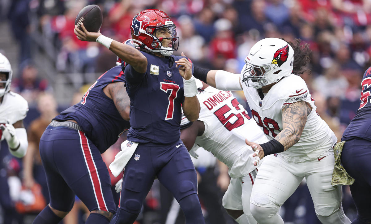 Nov 19, 2023; Houston, Texas, USA; Houston Texans quarterback C.J. Stroud (7) attempts a pass as Arizona Cardinals defensive tackle Roy Lopez (98) applies defensive pressure during the first quarter at NRG Stadium. Mandatory Credit: Troy Taormina-USA TODAY Sports